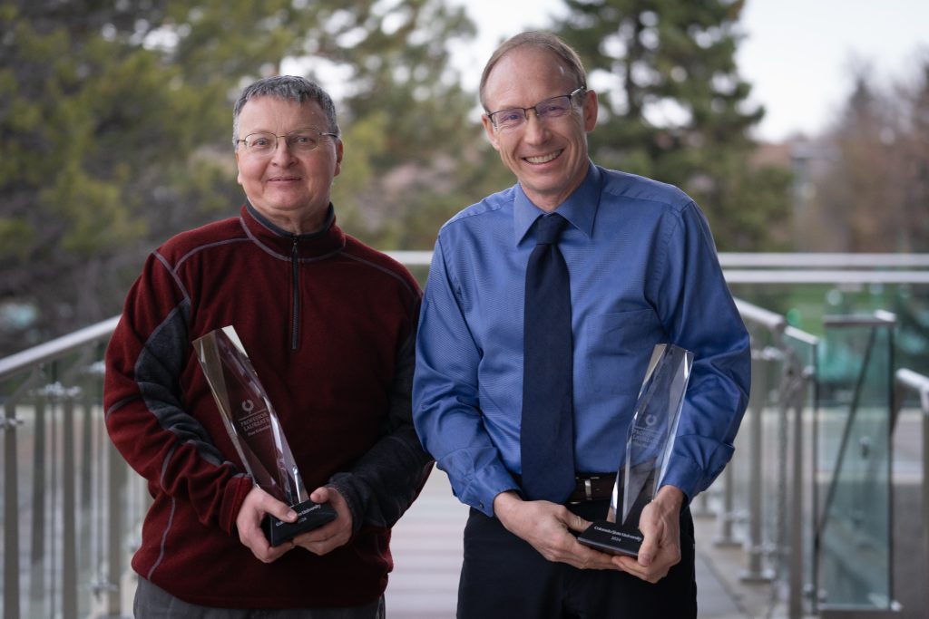 Olve Peersen and Piotr Kokoszka smile with their professor laureate awards.